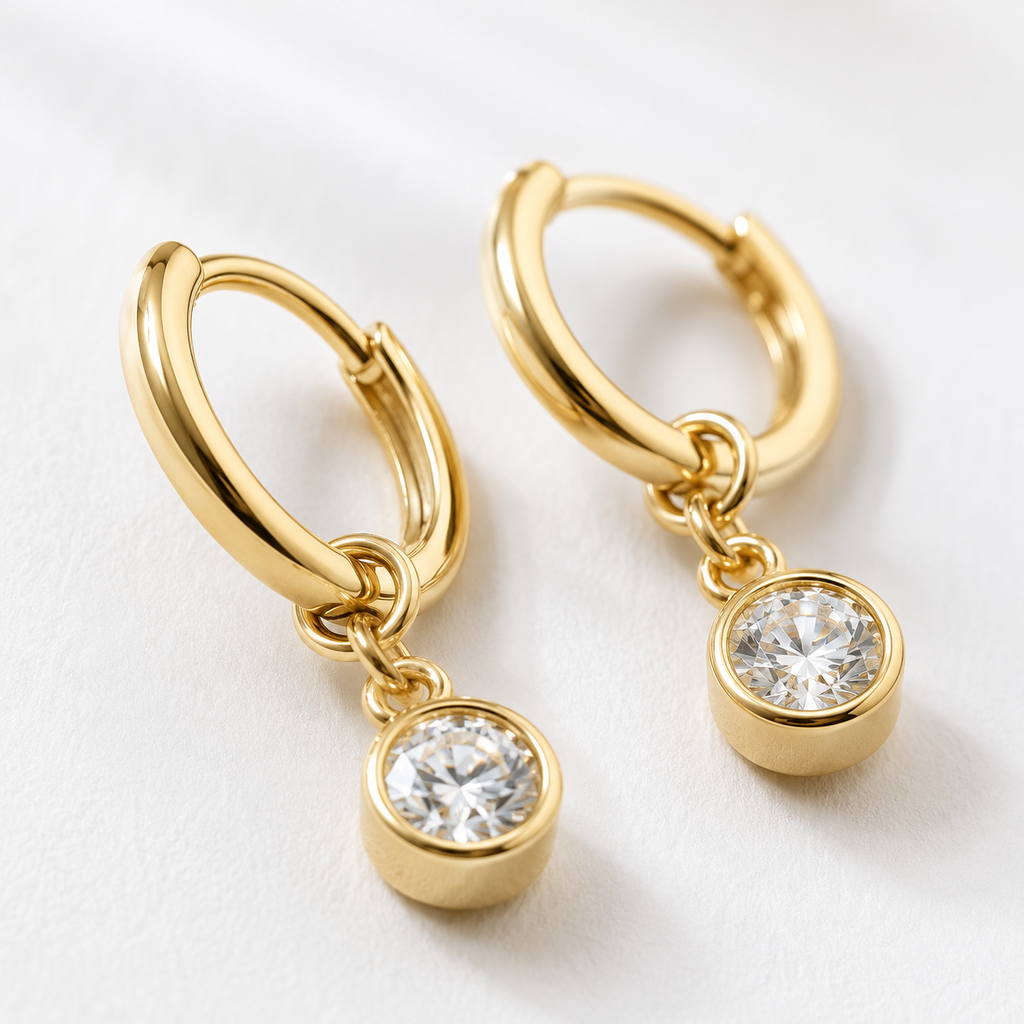 Close-up of Lueur bezel-set round diamond drop and 18K yellow gold hoop
