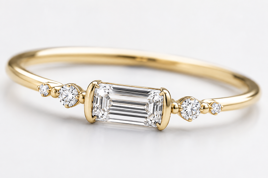 Close-up of Aureline emerald-cut center diamond and round side diamond setting
