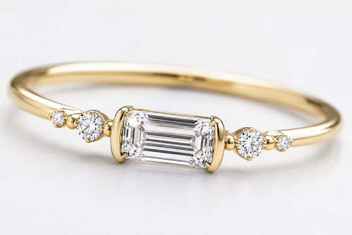 Close-up of Aureline emerald-cut center diamond and round side diamond setting
