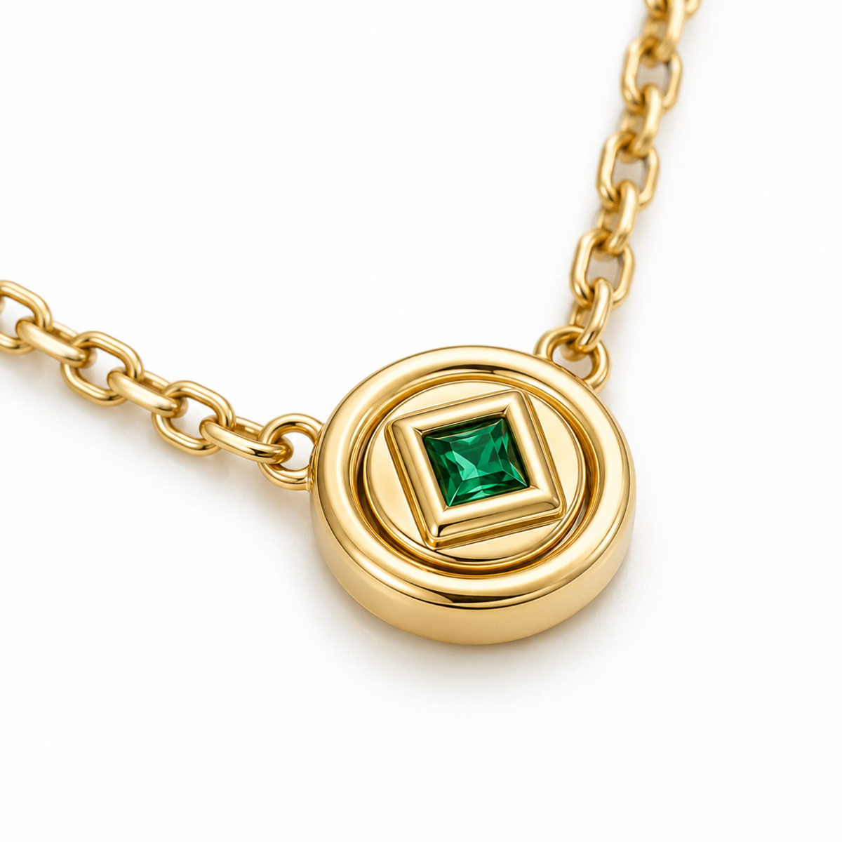 Close-up of square lab-grown emerald and sculptural 14K yellow gold medallion
