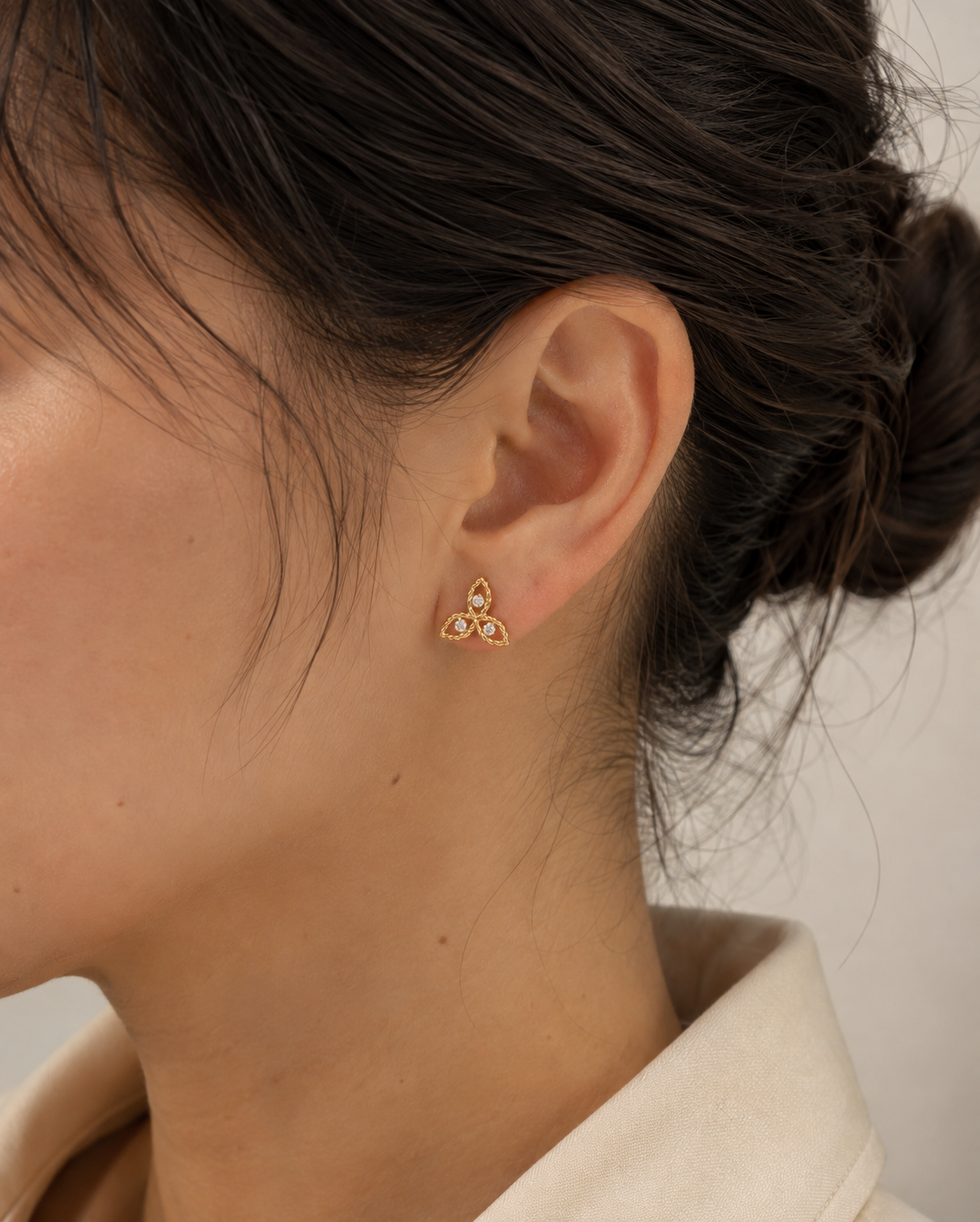 Diamond Flower Stud Earrings in 18K gold worn on the ears
