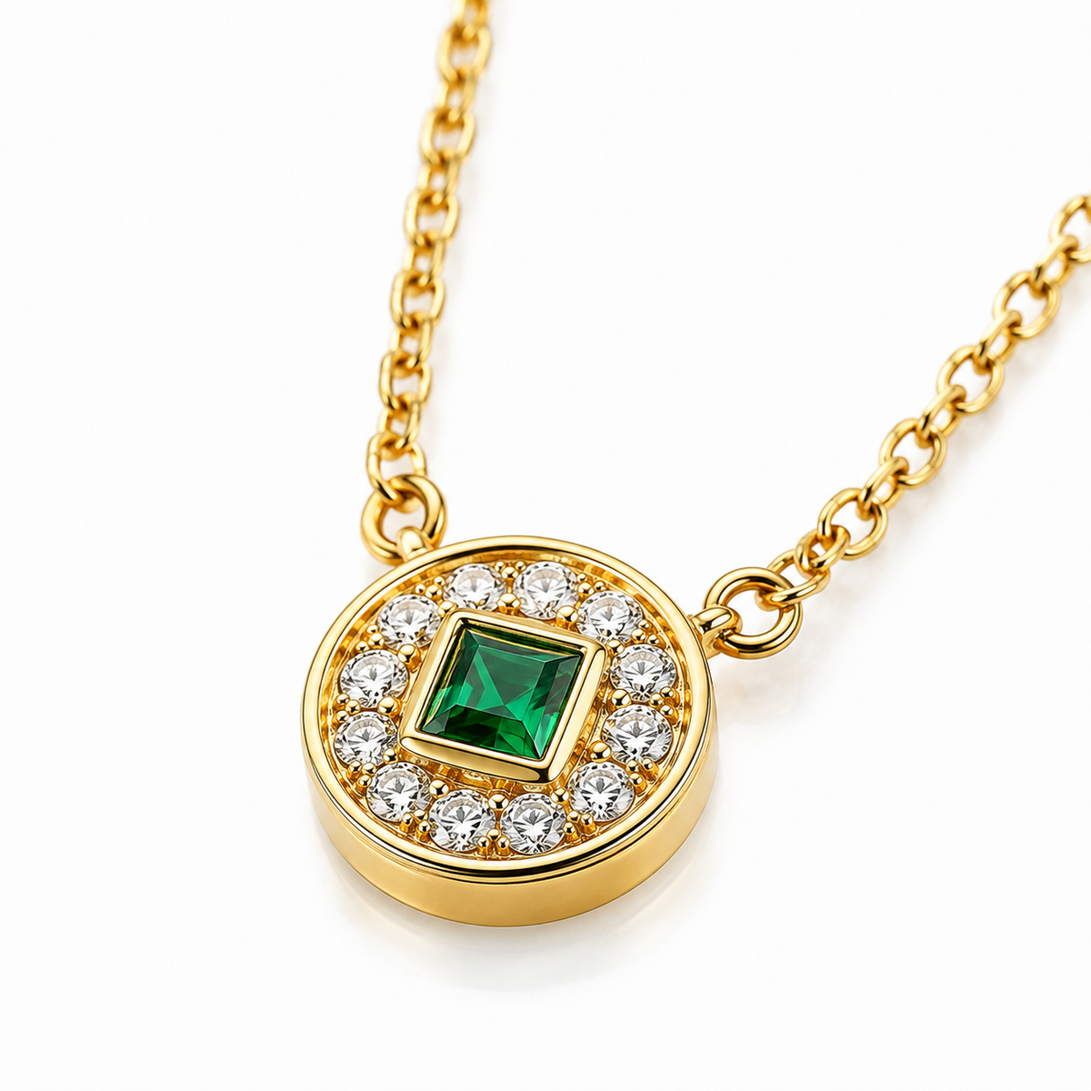 Close-up of square lab-grown emerald and pavé diamond medallion in yellow gold
